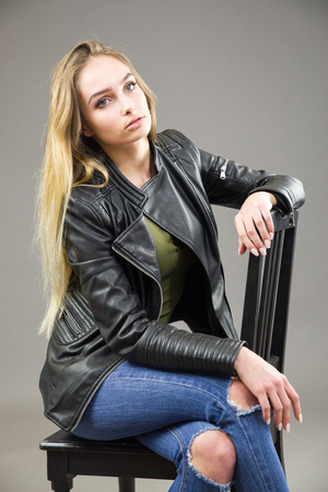 Blonde girl sitting on chairの写真素材
