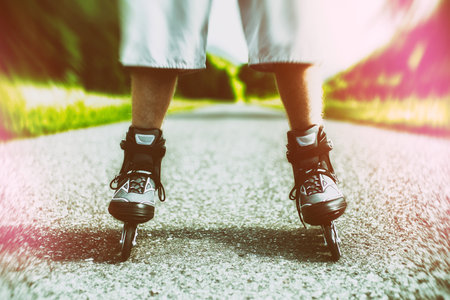 Roller skates. Inline skating on asphalt road.