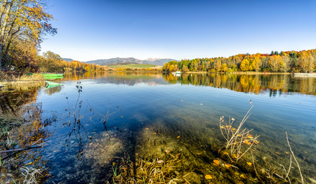 Reflection on leake. Colorful autumn trees. Water reservoir Liptovska Mara at Slovakiaの写真素材