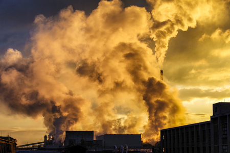 Air pollution. Smoking factory chimneys and sunlightsの写真素材