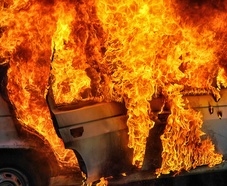 Burning car after accident on road. Flames and fireの写真素材