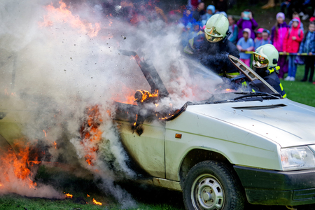 RUZOMBEROK, SLOVAKIA - SEPTEMBER 9: Firemans and burning car on September 9, 2017 in Ruzomberokのeditorial素材