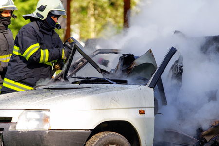 RUZOMBEROK, SLOVAKIA - SEPTEMBER 9: Firemans and burning car on September 9, 2017 in Ruzomberokのeditorial素材