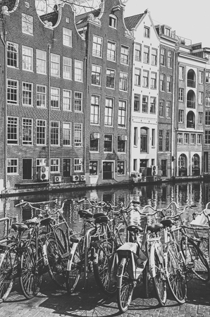 AMSTERDAM, NETHERLANDS - APRIL 3: Bicycles, water canal and typical architecture in city on April 3, 2014 in Amsterdamのeditorial素材