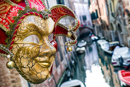 VENICE, ITALY - FEBRUARY 11: Mask of clown and water canal at background during The carnival of Venice on February 11, 2018 in Veniceのeditorial素材