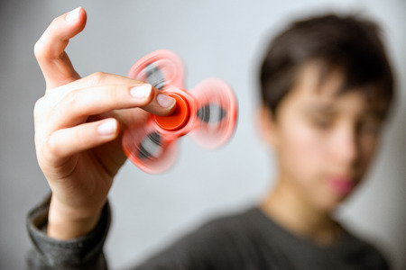 Kid with red fidget spinner in handの写真素材