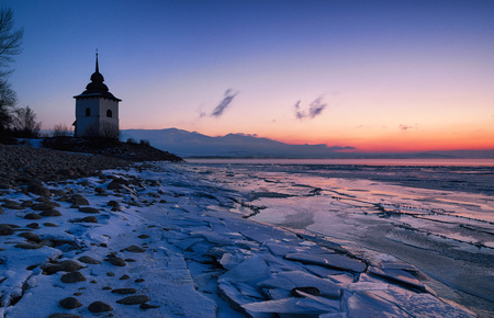 Colorful sunrise and tower of church at water reservoir Liptovska Mara, Slovakia. Colorful skyの写真素材