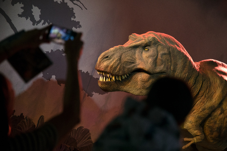 LONDON, UNITED KINGDOM - MAY 13: Model of dinosaur tyrannosaurus Rex and visitors in Natural history museum on May 13, 2018 in Londonのeditorial素材