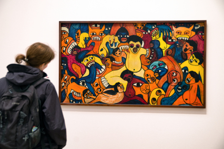 LONDON, UNITED KINGDOM - MAY 12: Visitor looking at Malangatana Ngwenya painting Untitled at Tate modern on May 12, 2018 in Londonのeditorial素材