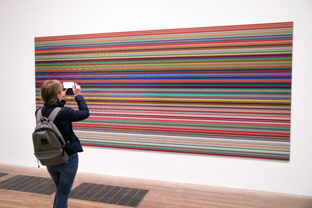 LONDON, UNITED KINGDOM - MAY 12: Woman looking at abstract art at Tate modern on May 12, 2018 in Londonのeditorial素材