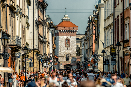 KRAKOW, POLAND - AUGUST 18: Overcrowded city and St. Florians gate at background on August, 18, 2018 in Krakowのeditorial素材