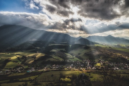 Sun rays and cloudscape over rural country. Cloudscape at sky. Region Orava, Slovakia. Hill Choc in cloudsの写真素材