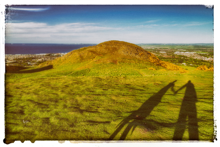 Shadow of lovers on the hill Arthur's Seat in Edinburgh. Lovely summer landscapeの写真素材