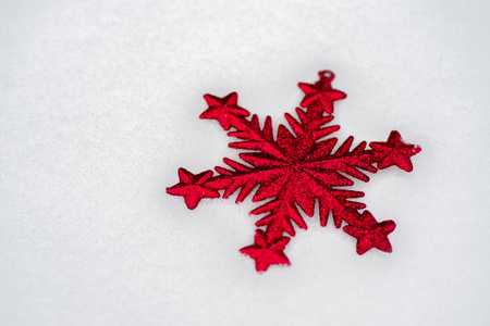 Red white ornamental star in the snow. Christmas bacgroundの写真素材