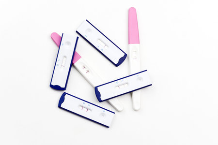 Many pregnancy test with positive results on white background