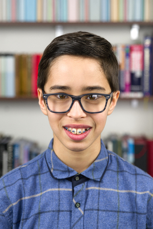 Smiling cute young boy with braces and glassesの写真素材