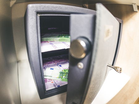 Open safe deposit box at home. Cash euro money insideの写真素材