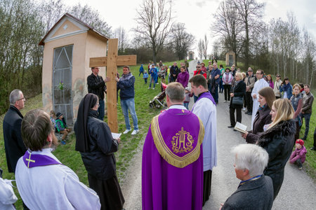 RUZOMBEROK, SLOVAKIA - APRIL 14: Nuns with cross at calvary. The Way of the cross during easter on...
