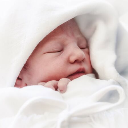 Sleeping baby and mother in hospitalの写真素材