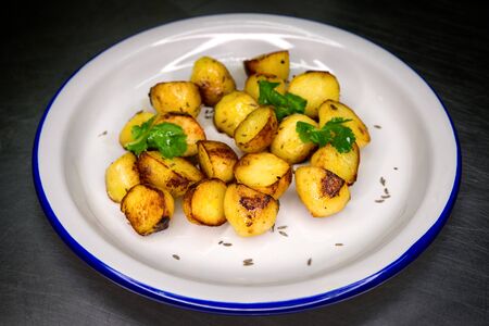Side dish - cooked potatoes on white plateの写真素材