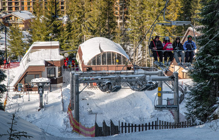 DEMANOVSKA DOLINA, SLOVAKIA - FEBRUARY 8: Skiers sitting on ski lift chair in resort Jasna in Low Tatras mountains on February 8, 2020 in Demanovska Dolinaのeditorial素材