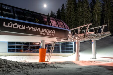 DEMANOVSKA DOLINA, SLOVAKIA - FEBRUARY 8: Empty ski lift chair at night in ski resort Jasna on February 8, 2020 in Demanovska Dolinaのeditorial素材