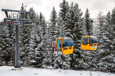 Cabin of cableway and skiers on slope at resort Malino Brdo, Slovakiaのeditorial素材