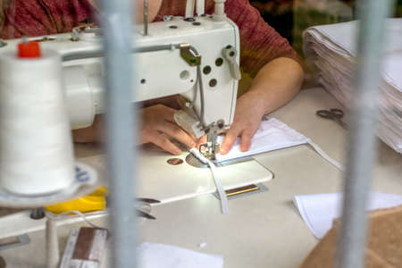 Sewing a face mask on sewing machineのeditorial素材