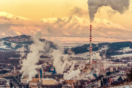 RUZOMBEROK, SLOVAKIA - DECEMBER 29: Smoke from chimney at factory in town at December 29, 2019 in Ruzomberokのeditorial素材