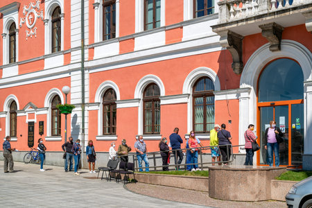 RUZOMBEROK, SLOVAKIA - MAY 22, 2020: People in face masks waiting in line due social restrictions...