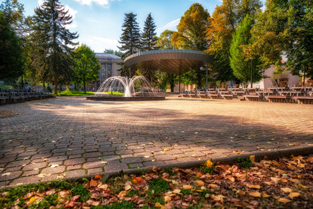 Colorful autumn leaves and long exposure fountain in autumn park in town Ruzomberok, Slovakia