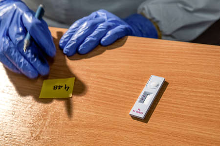 RUZOMBEROK, SLOVAKIA - OCTOBER 31, 2020: Doctor waiting for result of antigen test. Testing of Slovak population for COVID-19のeditorial素材