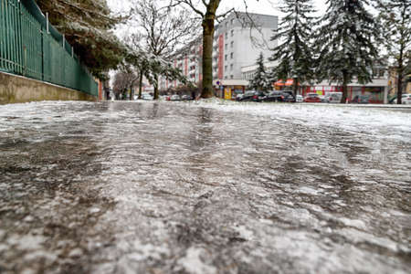 Sidewalk in city covered crust of ice.の写真素材