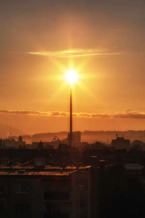 Colorful sunshine over smokestack in factory. Industrial sunriseの写真素材