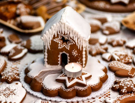 Christmas homemade gingerbread house with candle.の写真素材