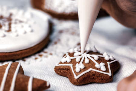 Decorating of Christmas homemade gingerbread cookies.の写真素材