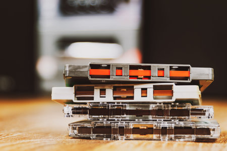 Old cassette tapes and hifi audio player at background.