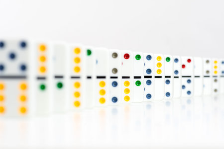Dominoes. Dominos pieces with colorful dots in row on white background