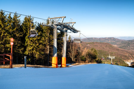 BANSKA STIAVNICA, SLOVAKIA - FEBRUARY 27, 2022: Chairs at ski-lift chair at Salamandra resort in winter season.のeditorial素材