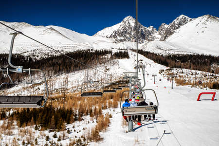 TATRANSKA LOMNICA, SLOVAKIA - MARCH 12, 2022: Ski-lift chairs in resort Tatranska Lomnica in High Tatras mountainsのeditorial素材