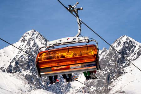 TATRANSKA LOMNICA, SLOVAKIA - MARCH 12, 2022: Ski lift and peak Lomnicky stit in High Tatras mountains in resort Tatranska Lomnica in winter seasonのeditorial素材
