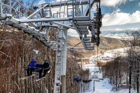 VALCA, SLOVAKIA - JANUARY 22, 2022: Skierssitting on ski-lift chair or chairlift at resort Snowland Valca in winter season.のeditorial素材
