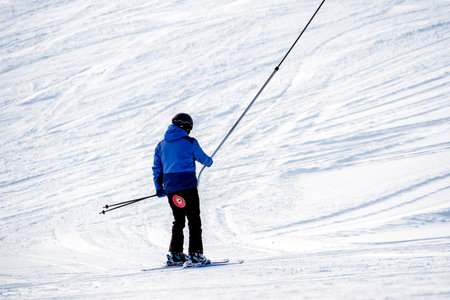 VALCA, SLOVAKIA - JANUARY 22, 2022: Skier ski-lift chair on slope in winter resort at mountain...
