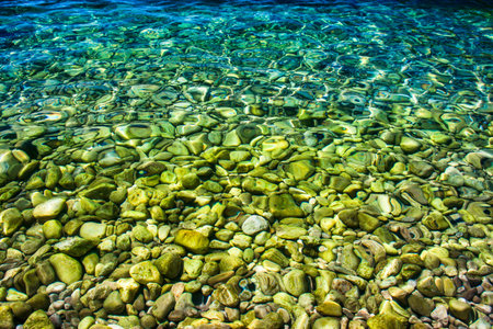 Crystal clear and turquoise water of sea. Pebbly beach