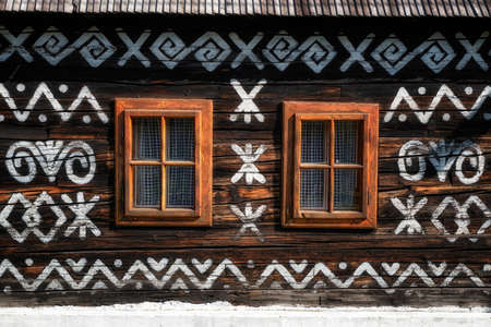 CICMANY, SLOVAKIA - AUGUST 25, 2021: Closed windows on old wooden cottage in village on the list of world heritage siteのeditorial素材