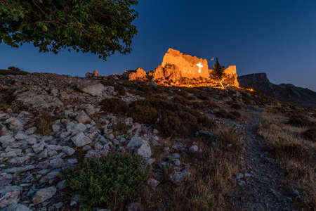 Ruins of Archangelos fort castle in Rhodes island, Greece. View on villageの写真素材