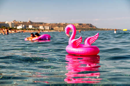 pink flamingo inflatable on the sea at resort Faliraki in Rhodes island, Greeceの写真素材