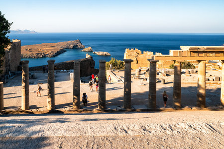 LINDOS, GREECE - JULY 1, 2022: Tourists in Lindos acropolis at Rhodes island in Greeceのeditorial素材