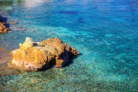 Crystal clear blue water in the sea with dry coastの写真素材
