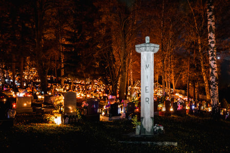 Ruzomberok, Slovakia - November 1, 2022: Candle lights on graves and tombstones in cemetery at night on All Souls Day or All Saints Dayのeditorial素材